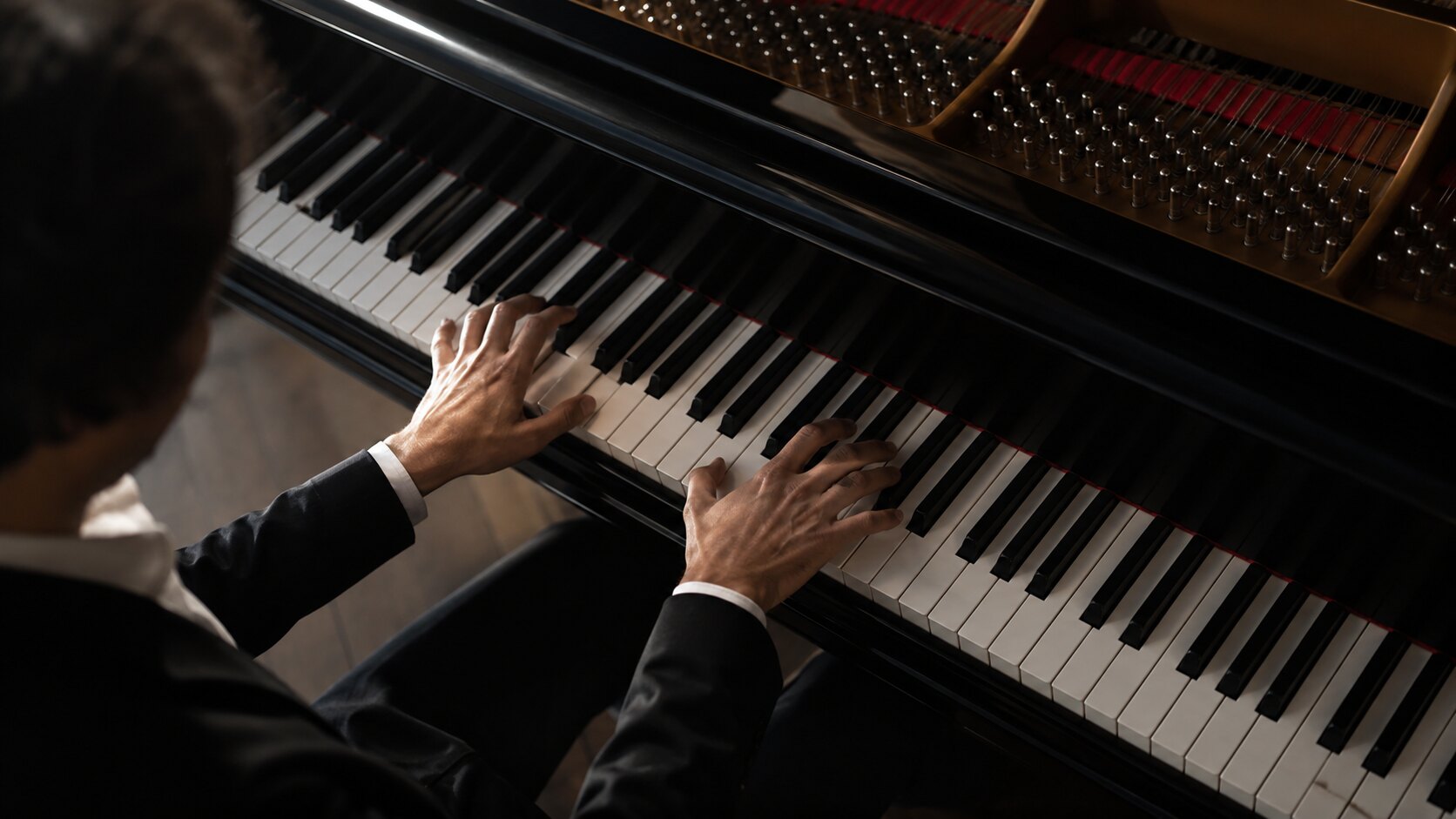 Pianist hands demonstrating technique on a grand piano